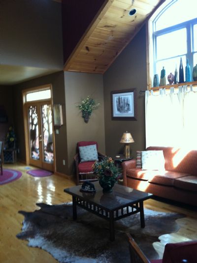 open loft living room with fireplace and views