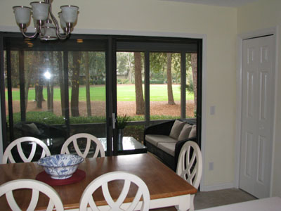 View from Kitchen to Screened Porch and Golf Fairway