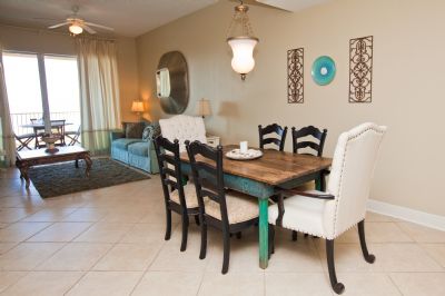 Large dining area with antique table and comfortable chairs