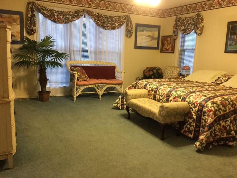 Master bedroom with king, sitting area