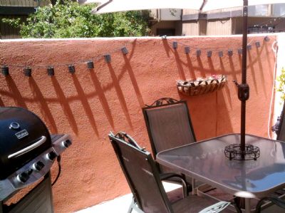Propane BBQ and covered table. Strung lights and small plants. Propane BBQ and covered table. Strung lights and small plants.