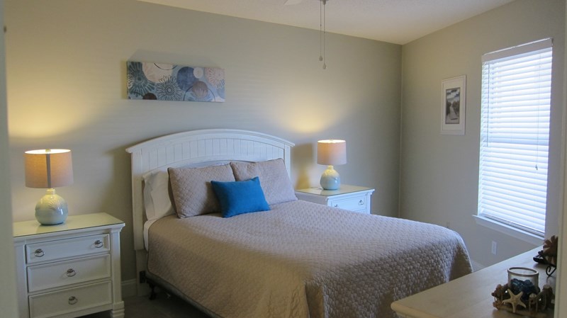 guest bedroom with a queen size bed