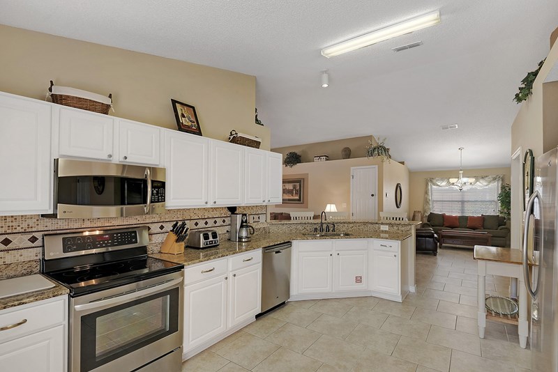 Well appointed kitchen features granite counter tops and stainless appliances