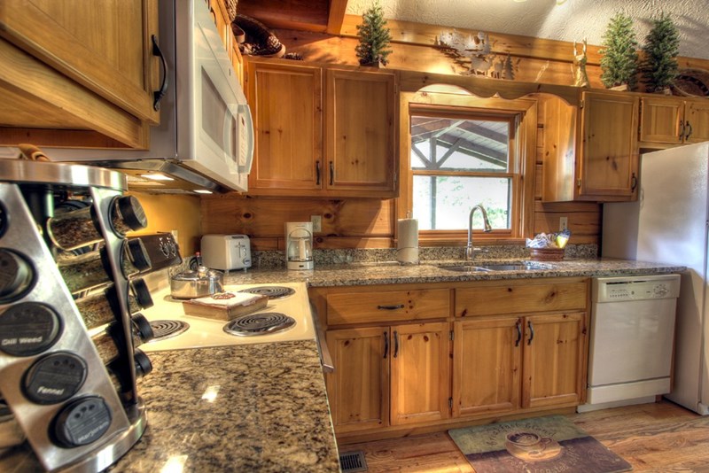 The Kitchen has a Newly Added Granite Countertop, a Deep Stainless Steel Sink and a Stainless Steel Faucet
