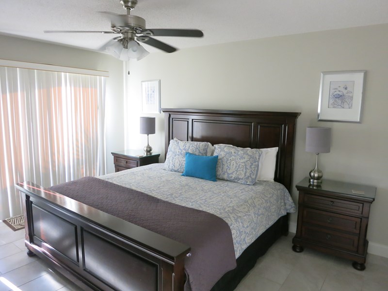 spacious master bedroom with a dark wood King size bed