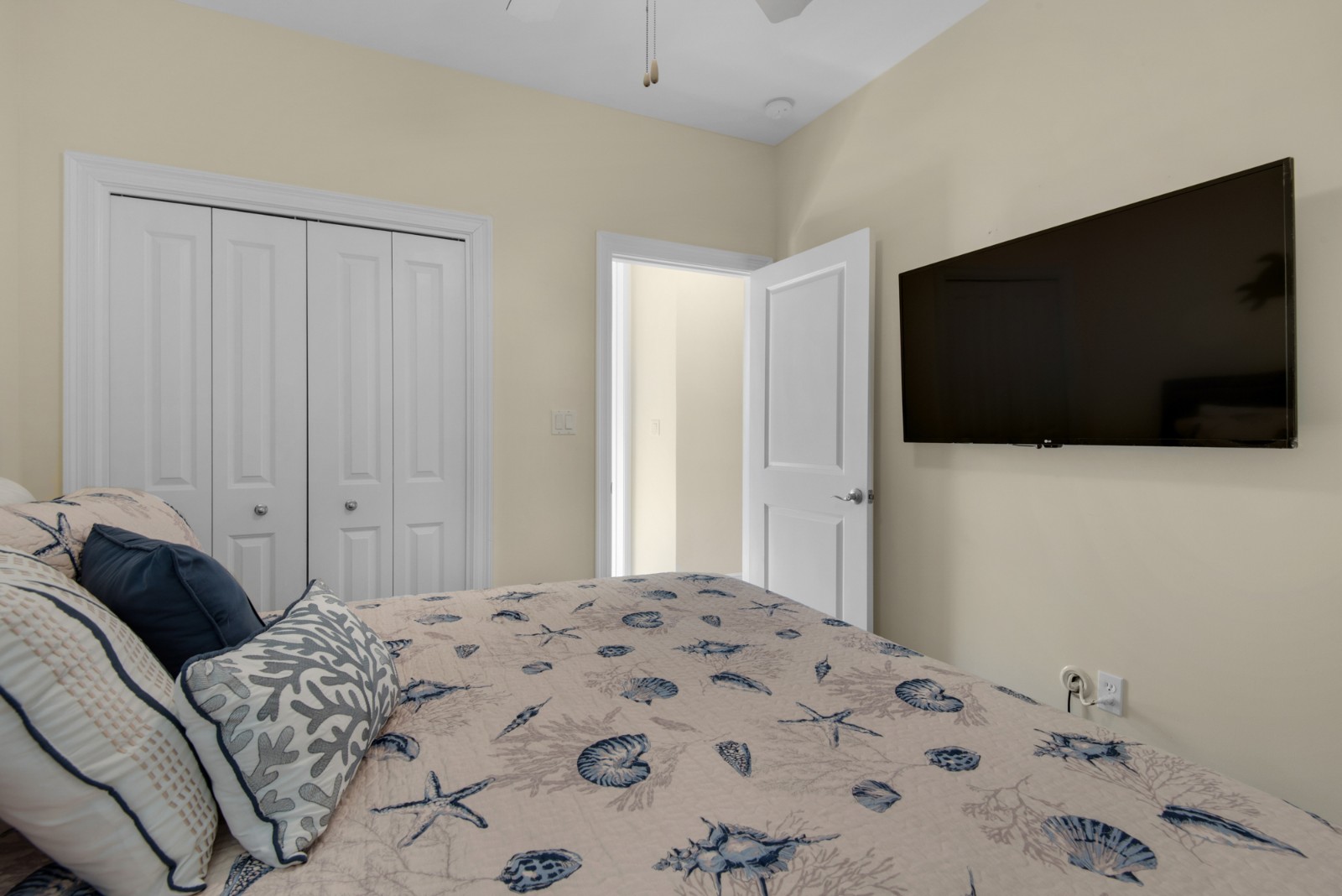 The first floor guest bedroom has a king bed and large 55