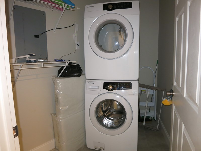Laundry room with a stack able washer and dryer.
