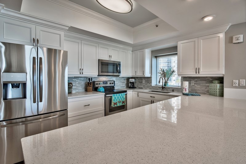 Brand new kitchen with quartz counter top, custom built cabinet and stainless steel appliances.